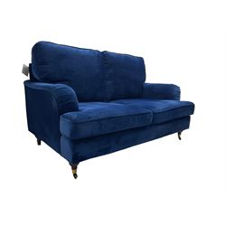 Howard design - two-seat sofa upholstered in blue fabric, traditional shape with rolled arms, on walnut finish turned feet with brushed metal cups and castors