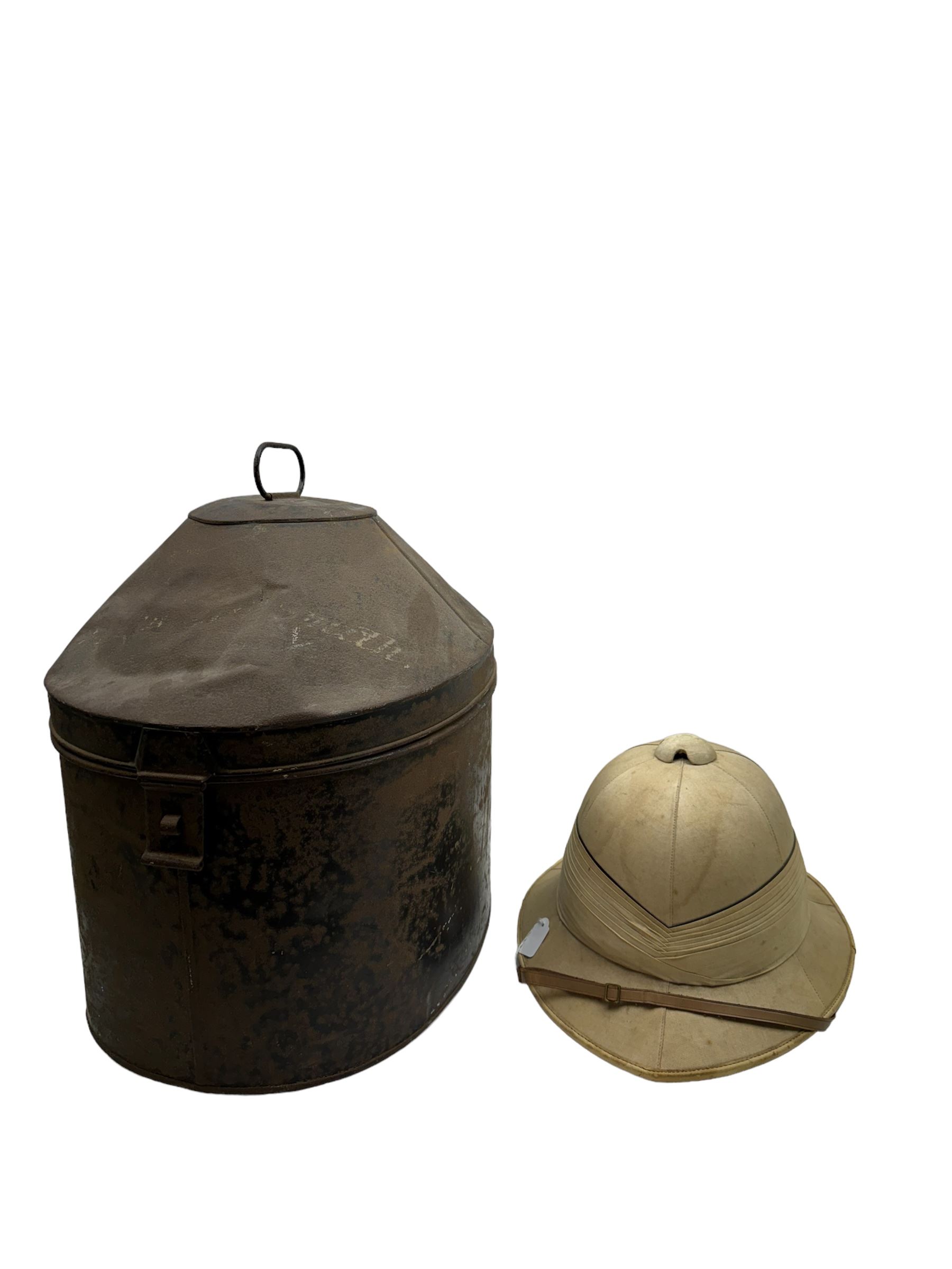 WWII Royal Navy officers sun helmet with large folded pagri and black top line, interior with green cloth covering to the peaks and original leather sweatband, with makers label 'Gieves Ltd London', with its original storage tin with indistinct painted lettering to the front 