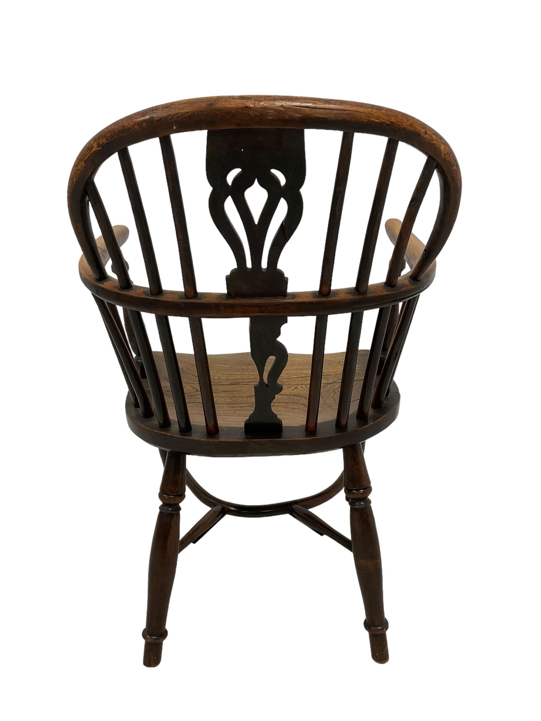 19th century yew wood and elm Windsor chair, low hoop stick back with pierced splat, dished seat raised on ring turned supports joined by crinoline stretcher