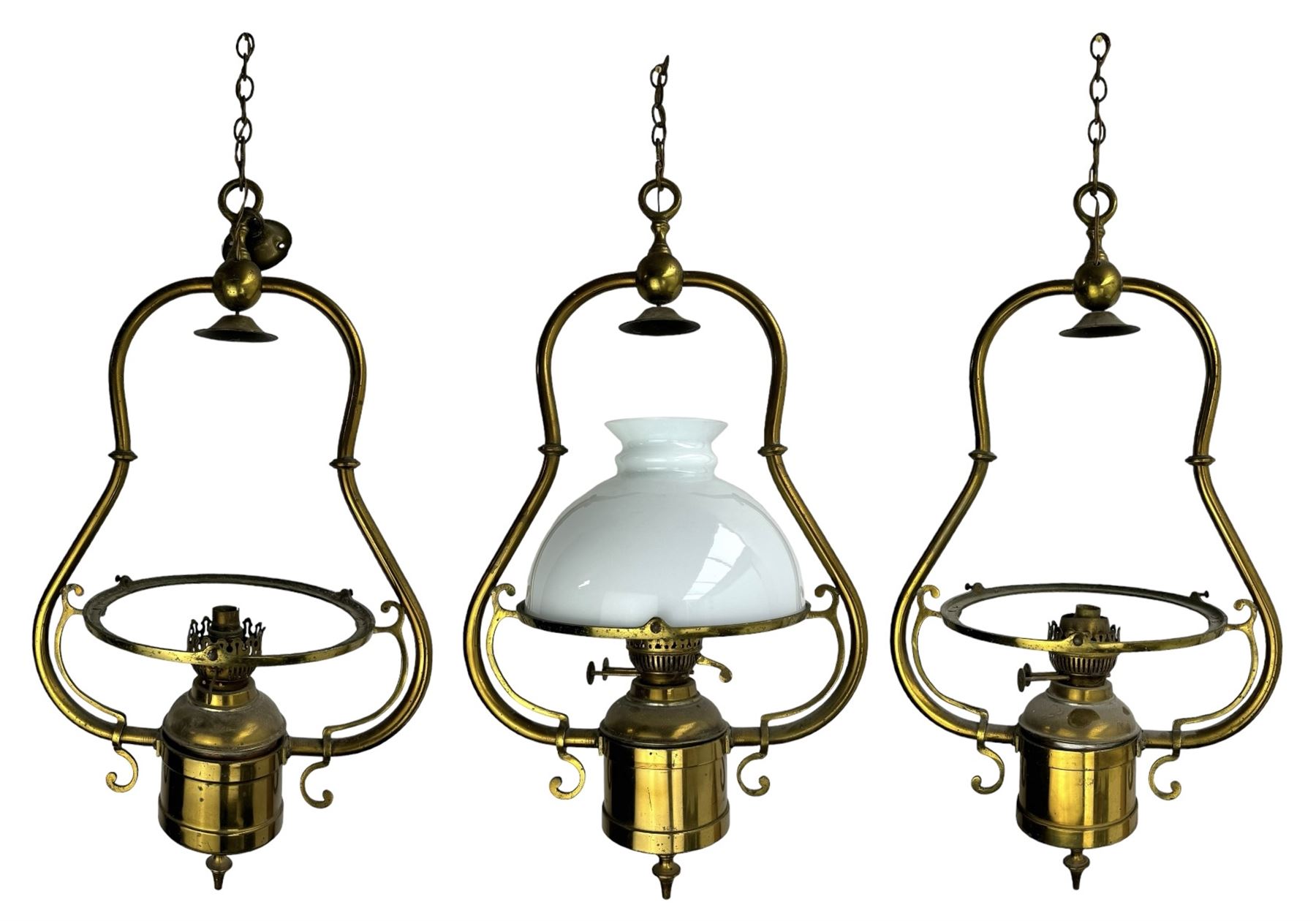 Set three brass framed light fittings, one with white glass shade, converted to electricity, H64cm