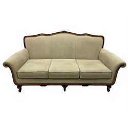 French design stained beech framed three-seat sofa, moulded frame carved with flowers and foliage, upholstered in pale neutral fabric, the moulded lower rail carved with flowerheads, on acanthus leaf carved cabriole feet