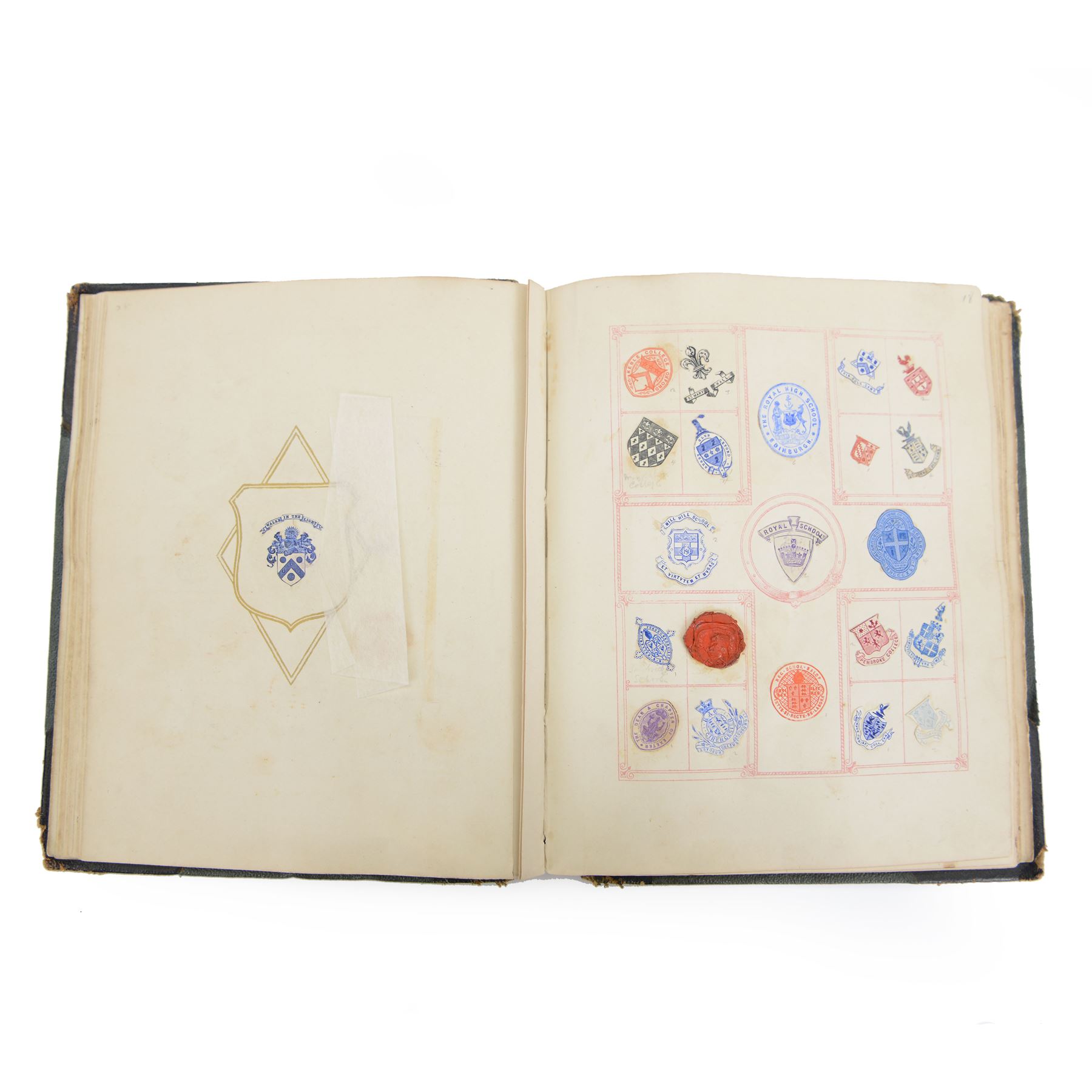 Victorian album of crests and monograms, including examples cut from envelopes and stamped into wax seals, with label to interior front cover reading 'Edward Law's Crest Collection Album 243' 