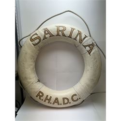 Four mid 20th century yacht lifebuoys, each painted in gold and black lettering 'Sarina R.H.A.D.C', upon a white ground, D68cm