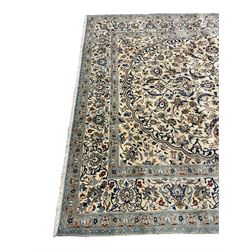 Persian ivory ground carpet, overall floral pattern with central rosette medallion, the field decorated with interlaced leafy branches and stylised plant motifs, guarded repeating border with repeating design