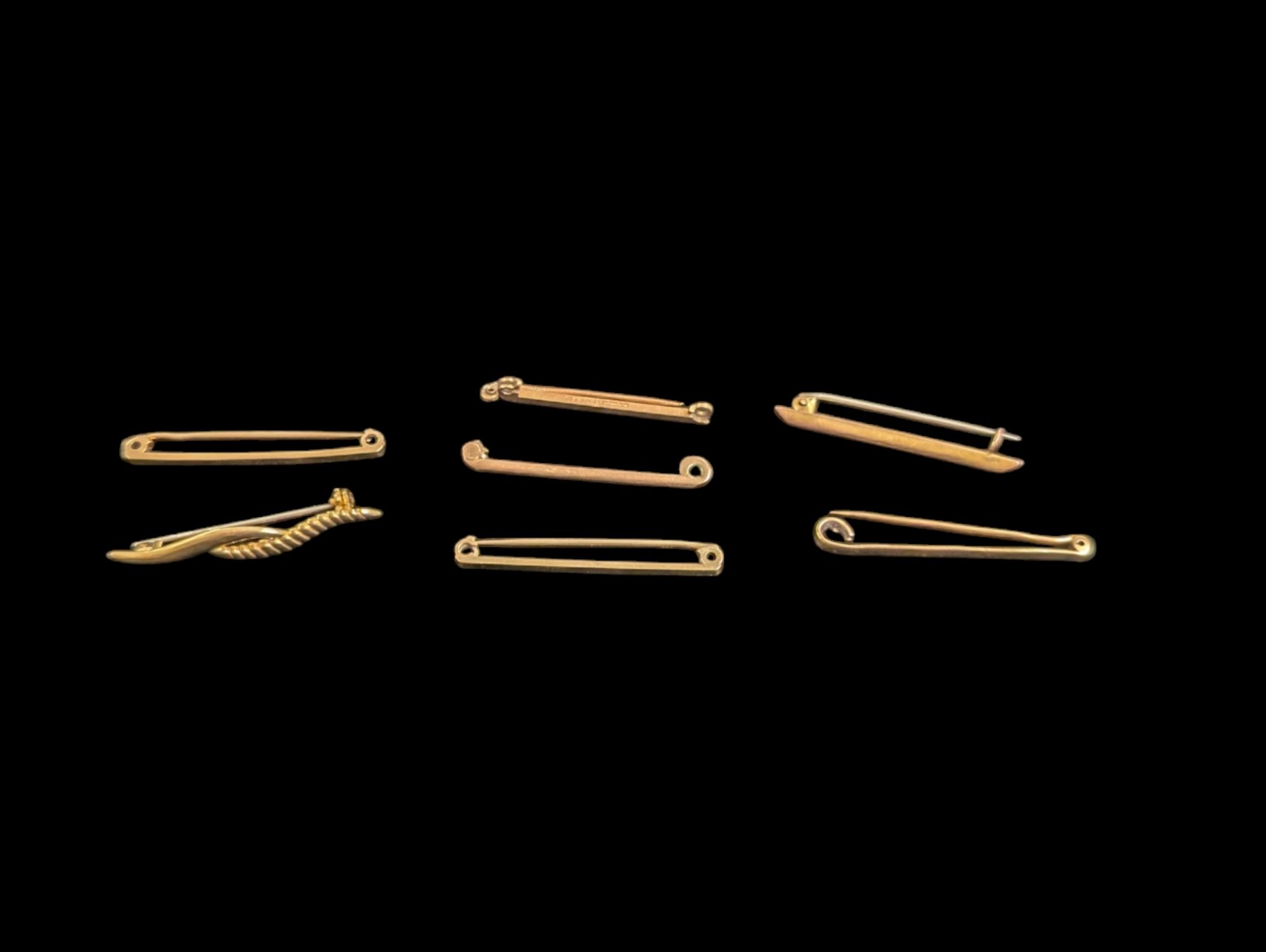 Gold bar brooches, including one 18ct example, one 15ct example and five 9ct examples, all stamped or hallmarked 