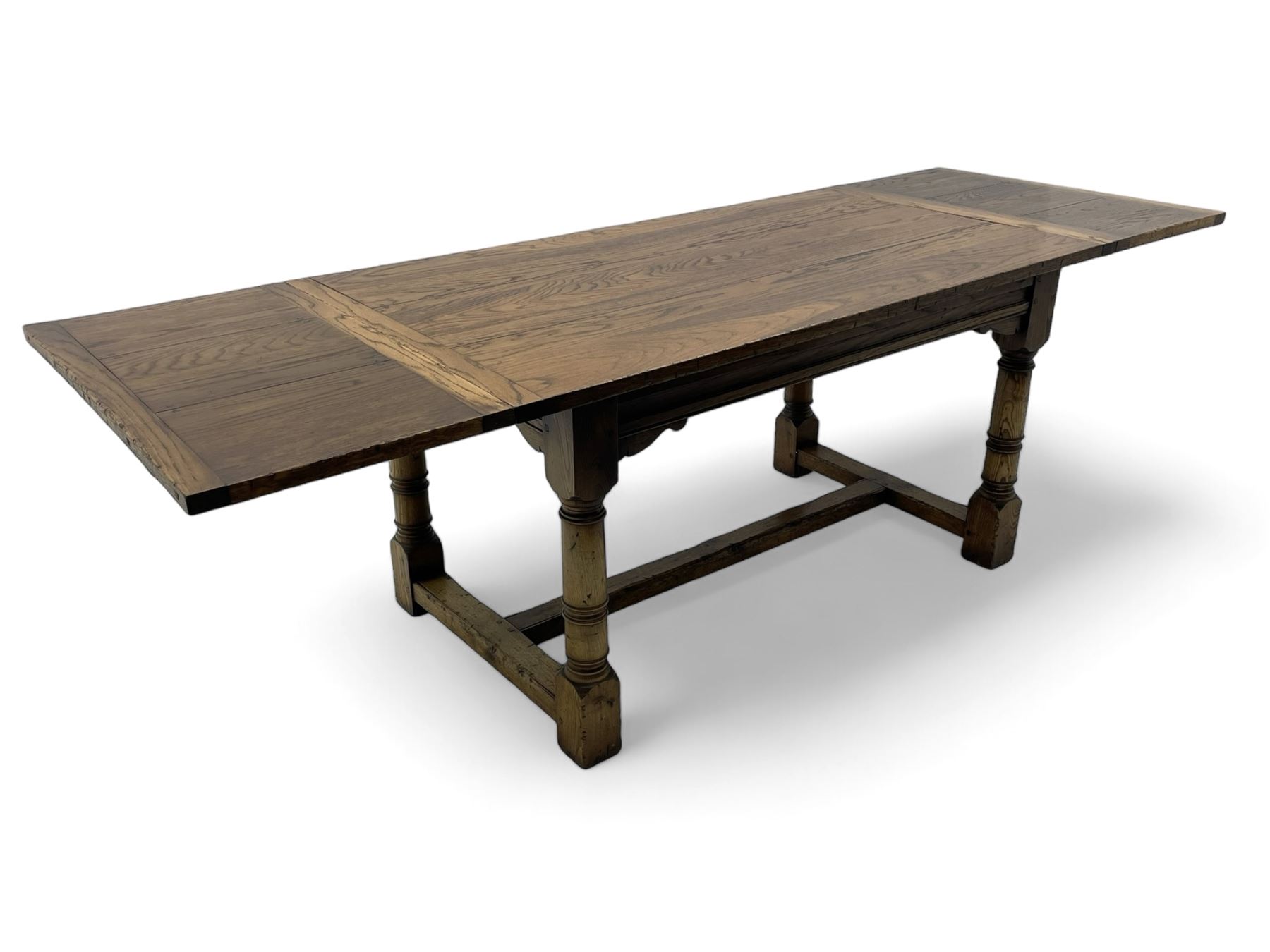 Oak refectory dining table, rectangular three plank top with cleated ends, two additional leaves, on turned supports united by H-stretchers 