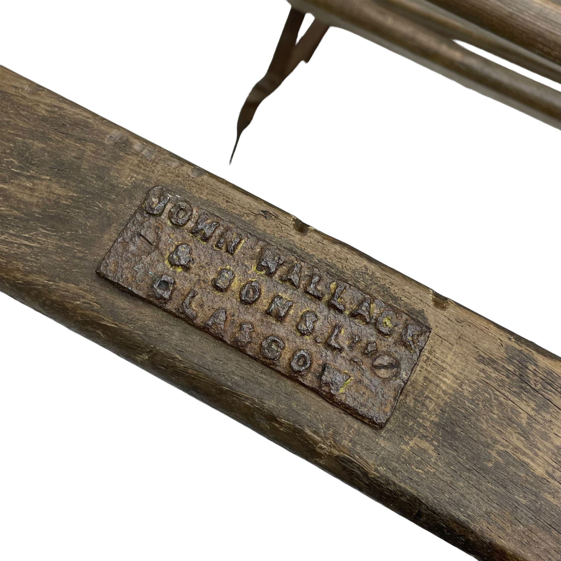 Victorian wrought metal strapwork and wooden ice sledge or chair, wooden slats on shaped strapwork frame and rail, makers plaque inscribed 'John Wallace & Sons Glasgow' 