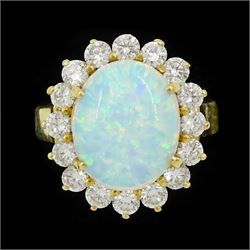 18ct gold opal and round brilliant cut diamond cluster ring, stamped, total diamond weight...