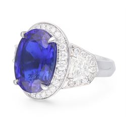 Platinum tanzanite and diamond ring, oval cut tanzanite, with round brilliant cut diamond surround, each side flanked by a single bullet cut diamond, with round brilliant cut diamond surround, hallmarked, tanzanite 9.16 carat, bullet cut diamonds 0.95 carat, round brilliant cut diamonds 0.83 carat