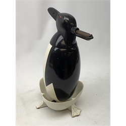 A Russian Soviet period soda siphon, modelled as an enamel penguin, and raised upon a plastic drip tray, H35.5cm 