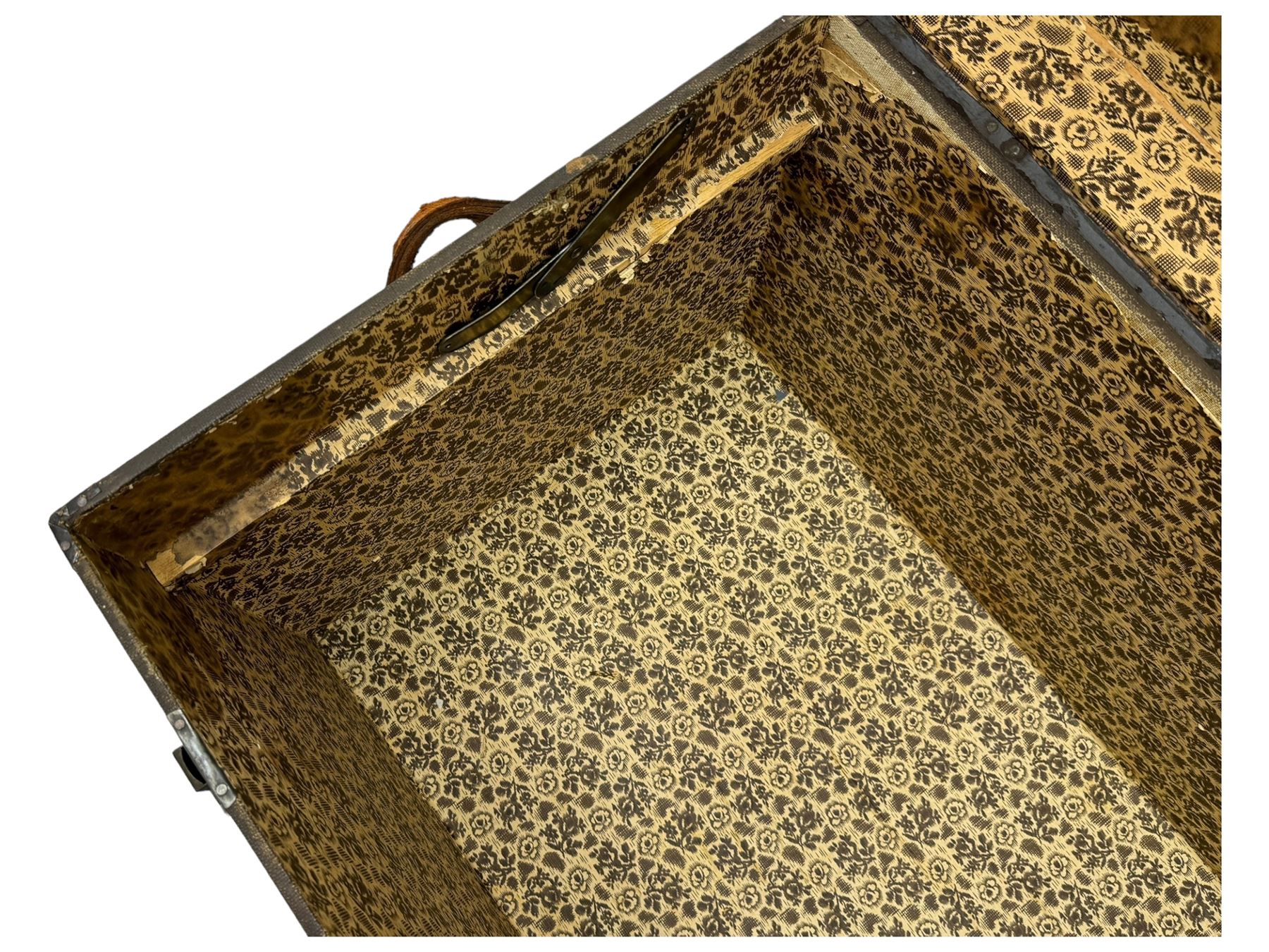 Early 20th century 'McBrine Baggage' steamer trunk, oak frame and black canvas covering, featuring metal hardware and leather straps, fitted with central lock, additional latches, and corner protectors, the interior is lined with floral-patterned paper and includes a removable top tray with makers label 