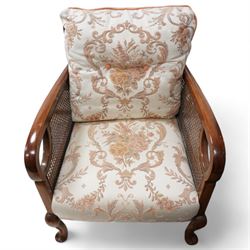 Early 20th century bergere lounge suite - two-seat sofa (W140cm, H80cm, D72cm); and pair of armchairs (W64cm); together with footstool, upholstered in floral fabric