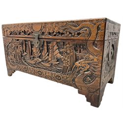 Chinese carved camphor wood blanked chest, rectangular hinged top, carved all over with traditional dragon motifs and junk ships