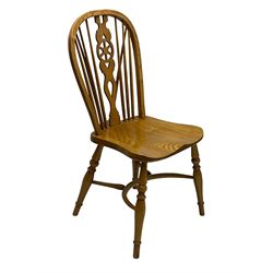 Set of four elm Windsor dining chairs, hoop and stick back with shaped wheel splat, dished seat on turned supports united by crinoline stretcher 