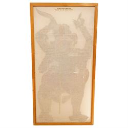 Javanese shadow puppet, painted, cut and pierced vellum, holding a knife, double sided frame 144cm x 69cm