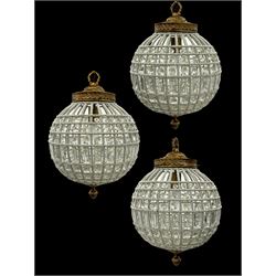 India Jane Interiors - set of three gilt metal and glass spherical ceiling light pendants, decorated with glass beads and pendants, foliage cast metal upper band, mounted by lower finial - ex-display/bankruptcy stock 