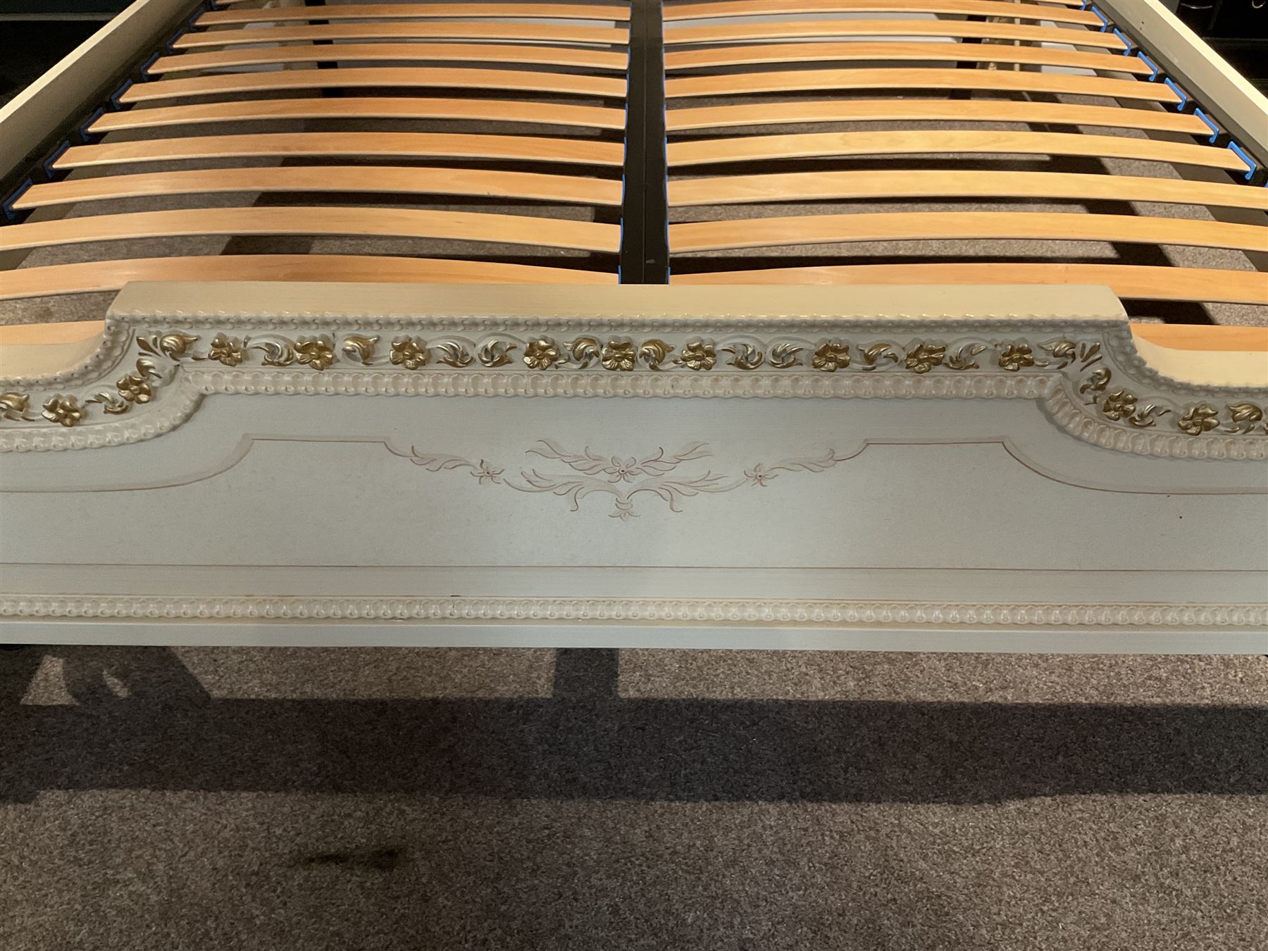 Barnini Oseo - super king 6' 'Reggenza' bedstead, the headboard with a pierced cartouche pediment with extending scrolling foliage, decorated with trailing gilt flower heads, upholstered in buttoned lilac velvet, raised on cabriole feet, in a cream finish