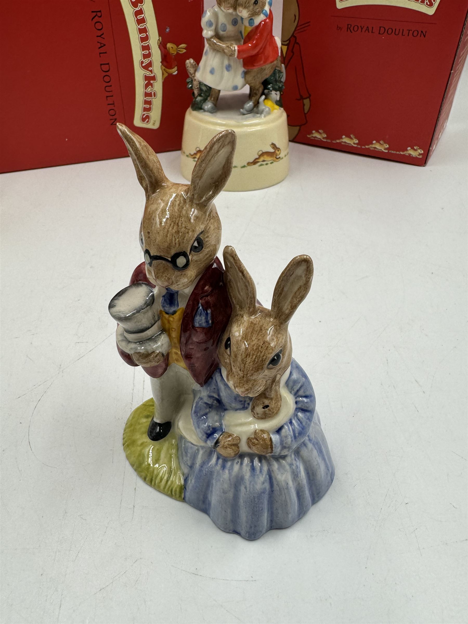 Two Royal Doulton Bunnykins music boxes, comprising Rocking Horse and Winter Waltz together with two Royal Doulton Bunnykins figures Once Upon a Time and Father, Mother & Victoria, all with original boxes  