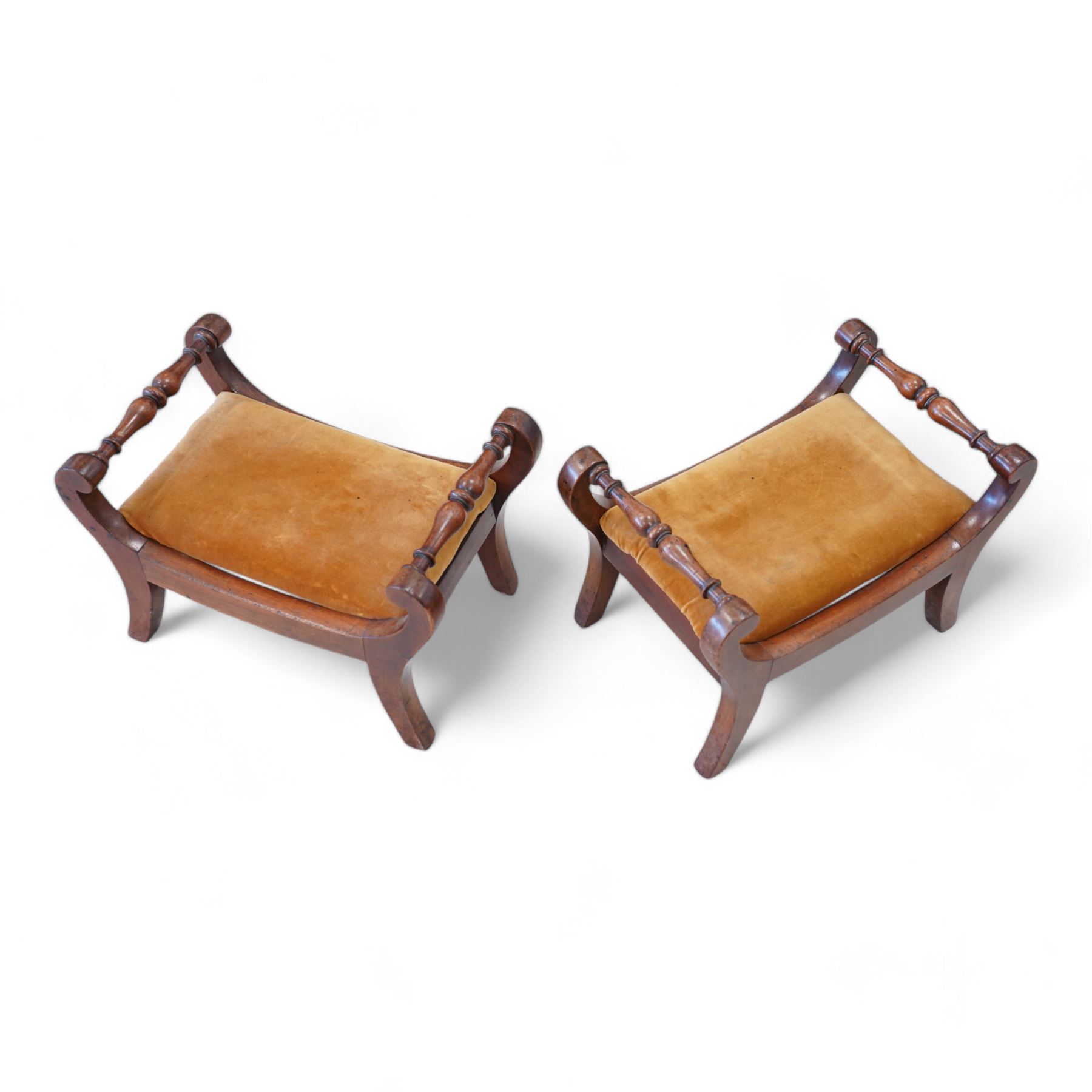 Pair of early to mid-19th century footstools, scroll uprights terminating to splayed feet, united by turned stretchers, drop-in seats upholstered in mustard fabric 