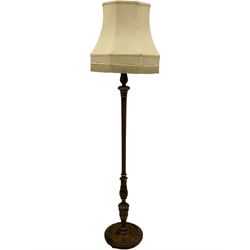 Early 20th century mahogany parcel gilt stained beech standard lamp, turned and fluted column carved with acanthus leaves, on circular base 