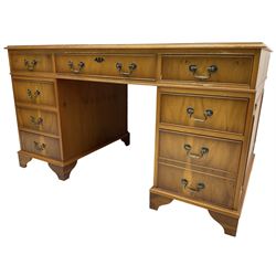 Georgian design yew wood twin pedestal desk, moulded rectangular top over nine cock-beaded drawers, on bracket feet