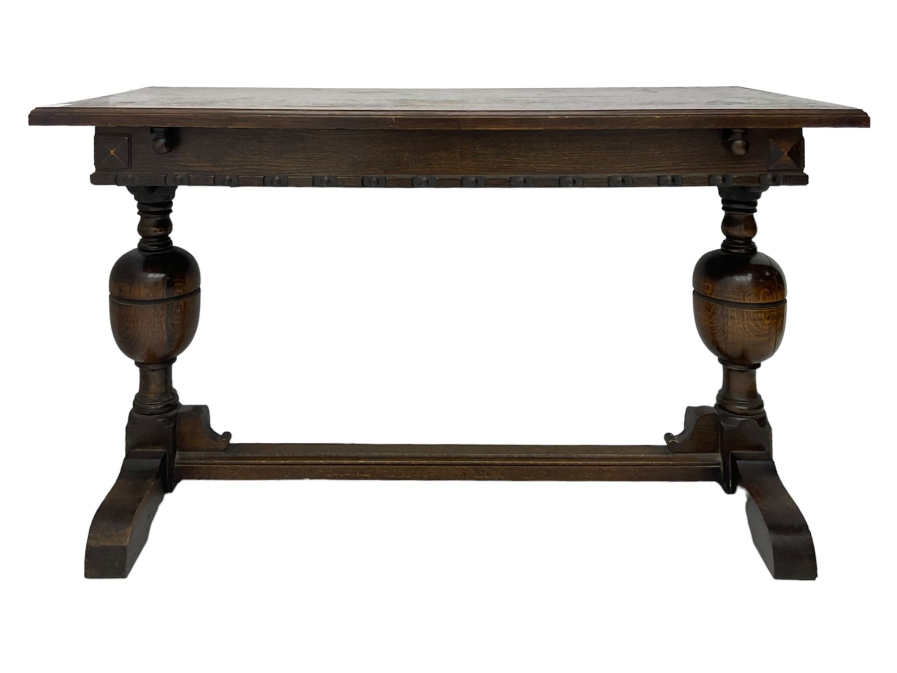 Early 20th century oak extending table, moulded rectangular top, pull-out action with fold-out leaf, on turned cup and cover pedestals and sledge feet, united by moulded stretcher 