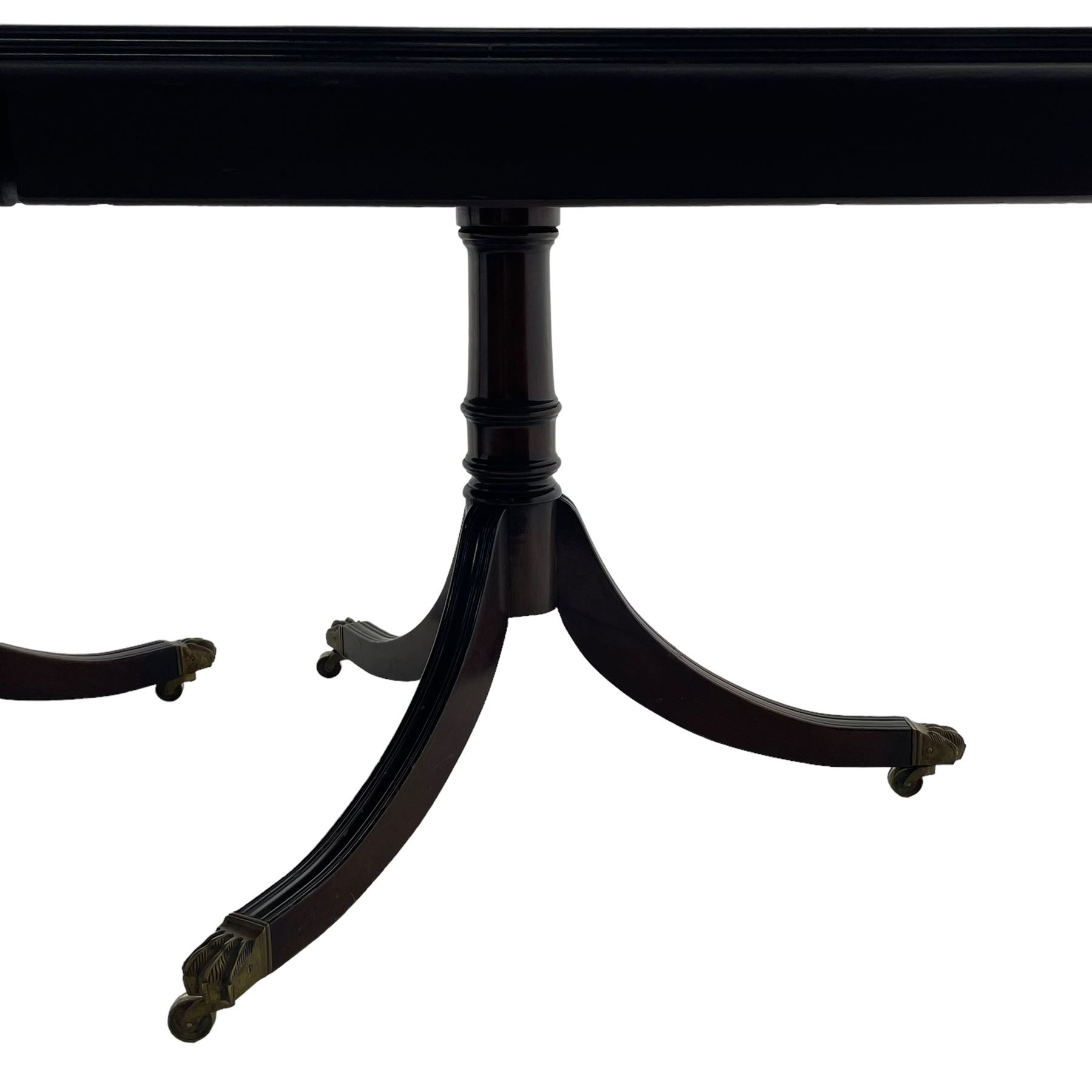 Georgian design mahogany 12' triple pillar dining table, two D-ends, centre and two additional leaves, rectangular top with rounded corners and boxwood stringing, on turned pedestals with moulded splayed supports, lion paw cast brass castors 