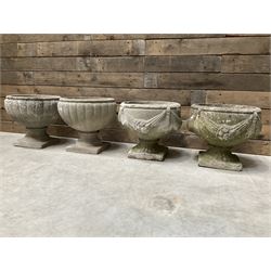 Pair of circular cast stone circular planters, and a similar pair decorated with swags (4)