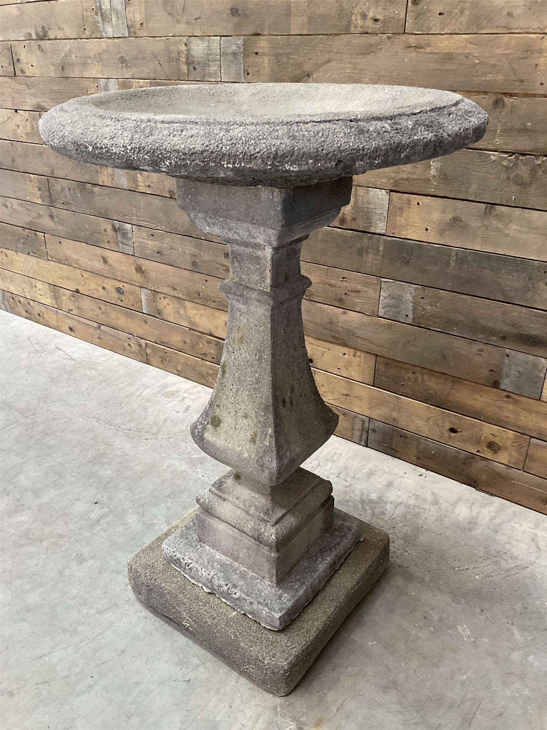 Cast stone garden bird bath, circular dished top, raised on square tapering column, on stepped base with separate mounting plinth