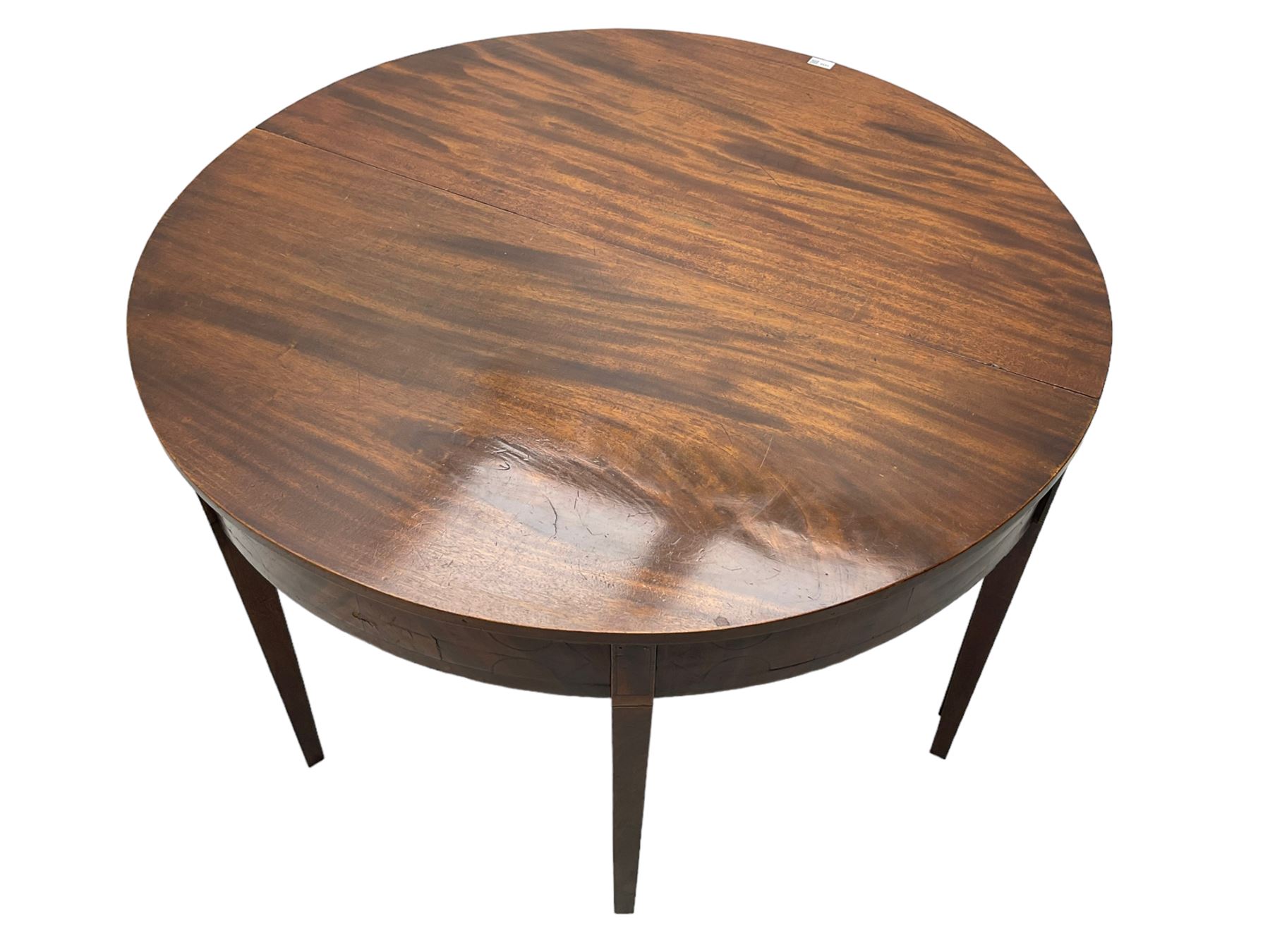 Regency mahogany D-ended extending dining table, circular top with banded fireze inlaid with ebony stringing, raised on square tapering supports, with two additional leaves, supported by gate-leg central action