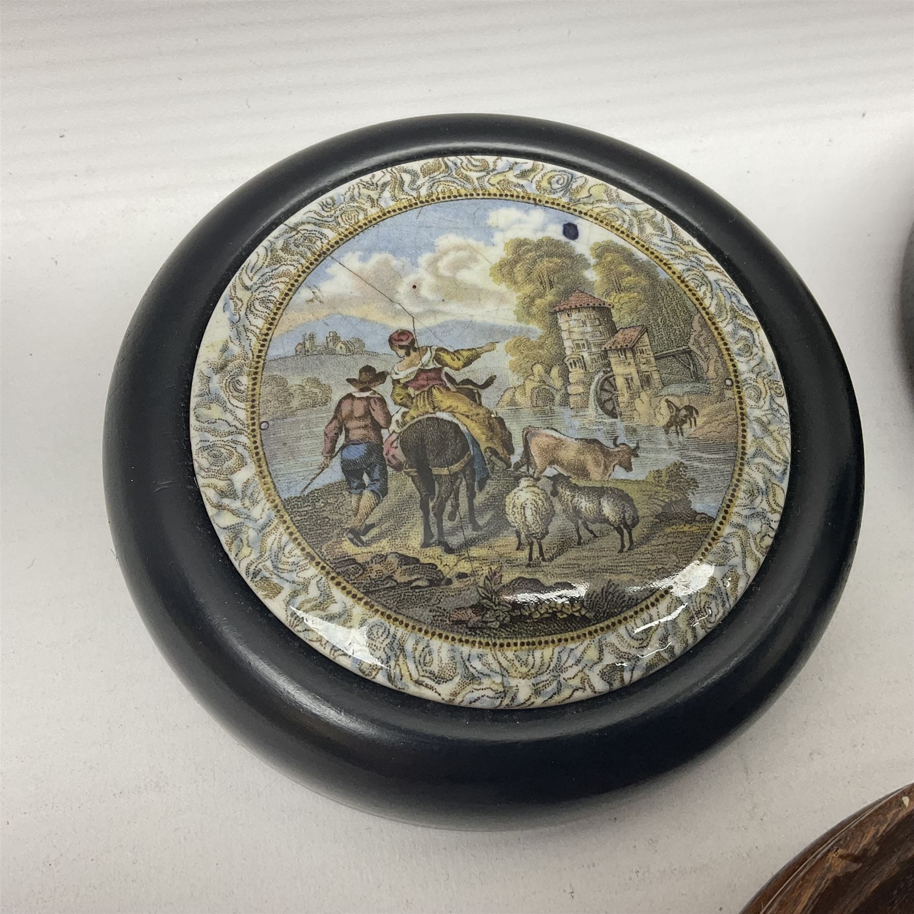 Six framed Prattware pot lids comprising 'Bear, Cock & Lion', 'Bear on Rock', 'Alas! Poor Bruin', ' Lady, Boy and Goats', 'The Shrimpers' and one other, largest D15.5cm (6)