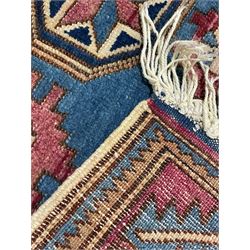 Turkish camel ground rug, three medallions surrounded by geometric motifs, the border decorated with stylised leaf motifs