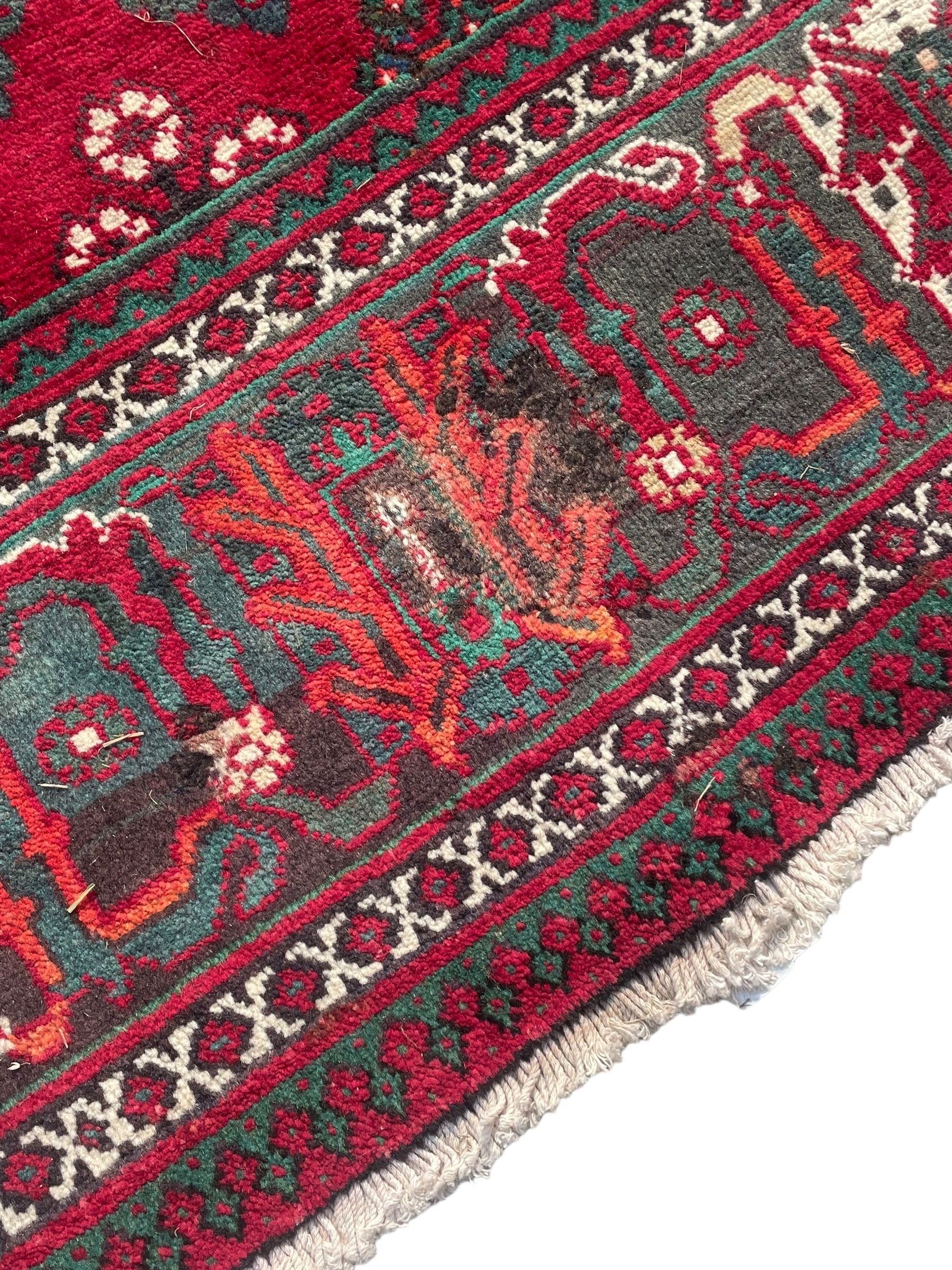 Persian Meymeh red ground rug, stepped lozenge medallion and spandrels, decorated all over with tree of life motifs, the main border decorated with repeating stylised plant motifs within geometric guard stripes 