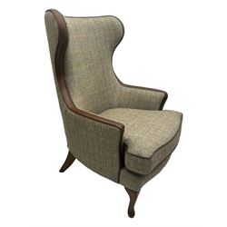 Wood Bros - contemporary wingback armchair, high back with curved wings upholstered in herringbone patterned fabric, accented with leather trim and brass nailhead studs, resting on cabriole front feet 