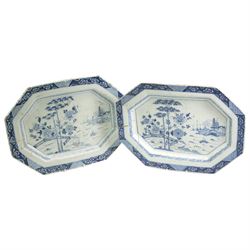 Two English Delft dishes, of canted rectangular form, painted with a fence, flowering plants and bamboo, within a scroll border, one marked F beneath, 49.5cm x 37.5cm max (2)