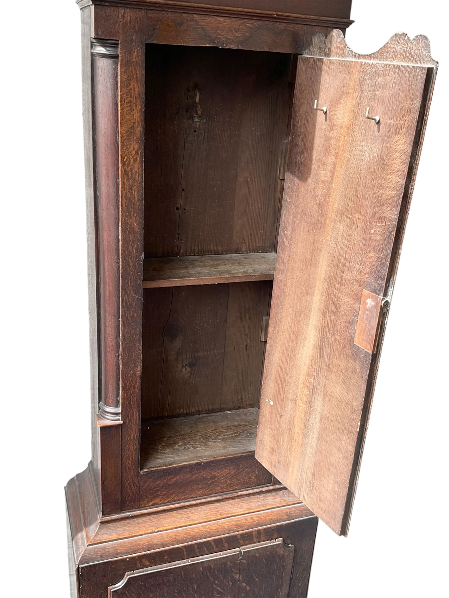 Empty oak longcase converted into a cupboard with shelves.