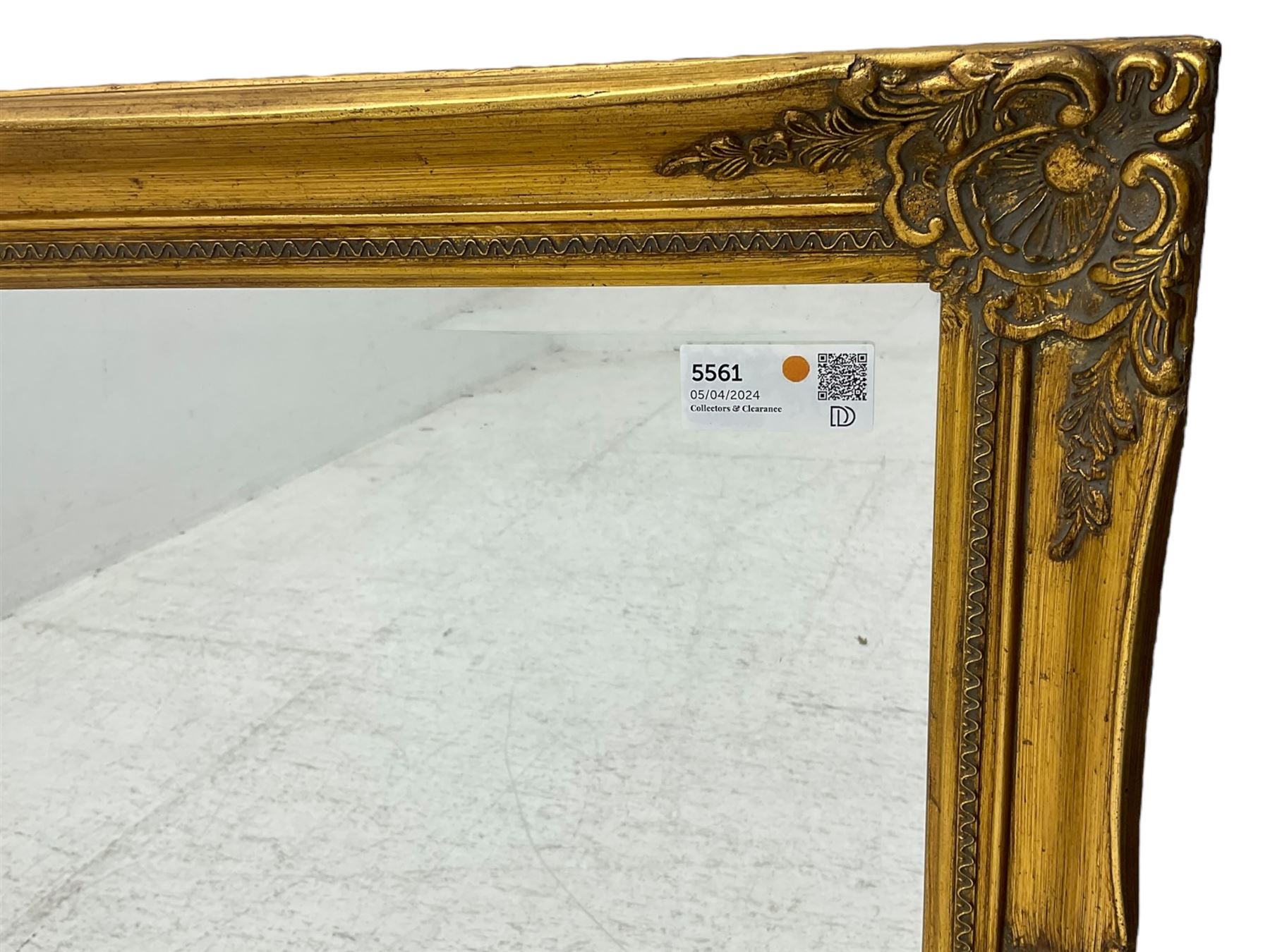 Swept gilt framed wall mirror with rectangular bevelled plate