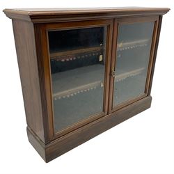 Phillips & Sons Ltd Bristol - Victorian mahogany glazed bookcase, projecting moulded cornice over two glazed doors, enclosing two shelves with scalloped edging, raised on a plinth base