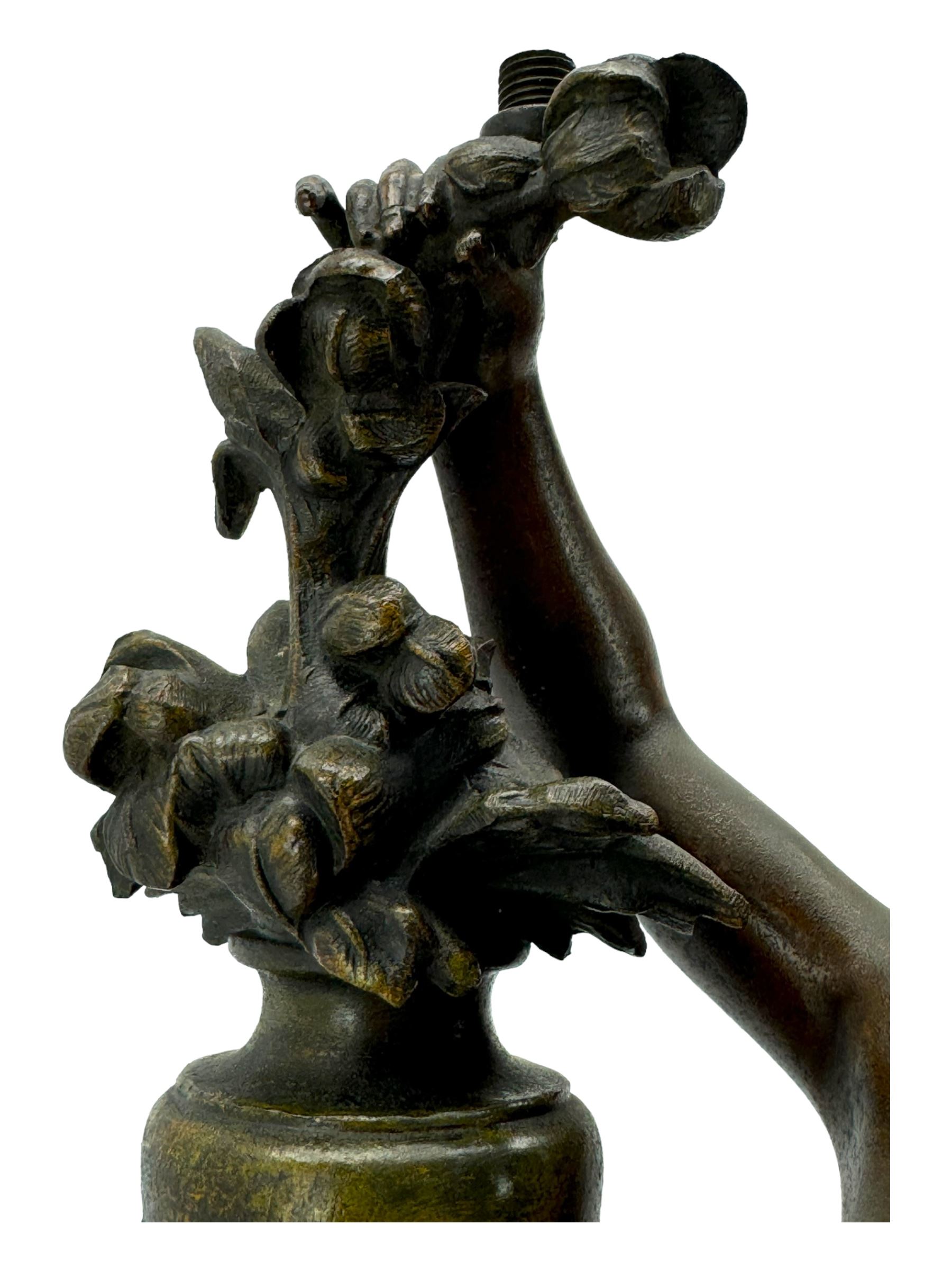 After L & F Moreau - Spelter table lamp in the form of a female figure next to a pedestal on circular naturalistic base H55cm