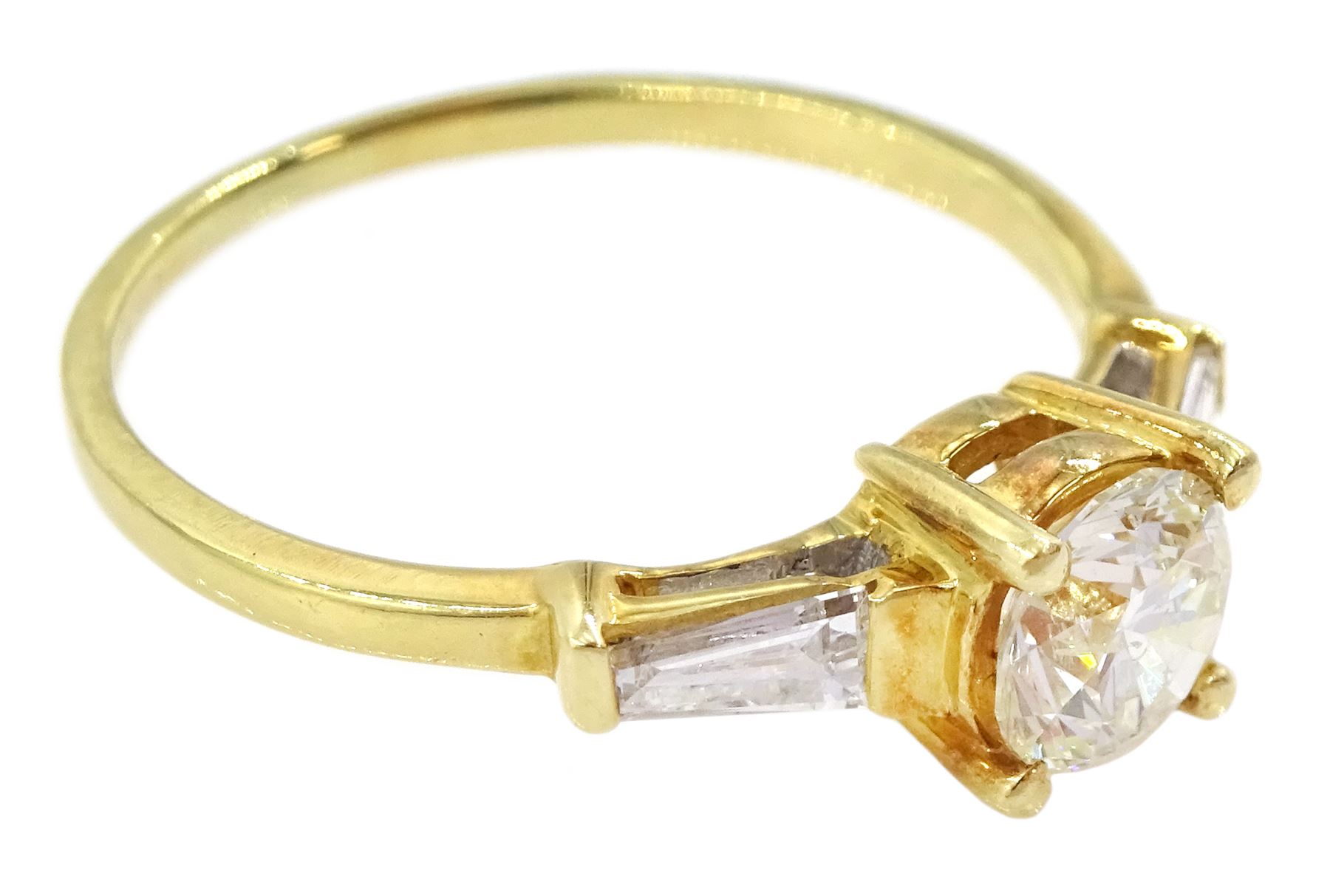 18ct gold single stone round brilliant cut diamond ring, with tapered baguette diamond shoulders, stamped 750, principal diamond approx 0.65 carat, total diamond weight approx 0.85 carat