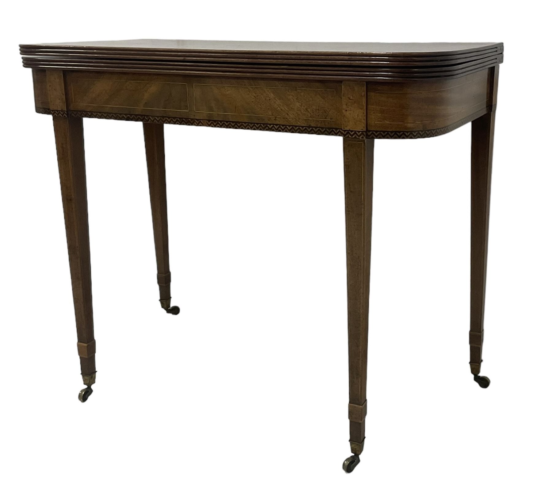 19th century mahogany tea table, fold-over top with reeded edge over inlaid frieze, on double gate-leg action square tapering supports, with brass castors