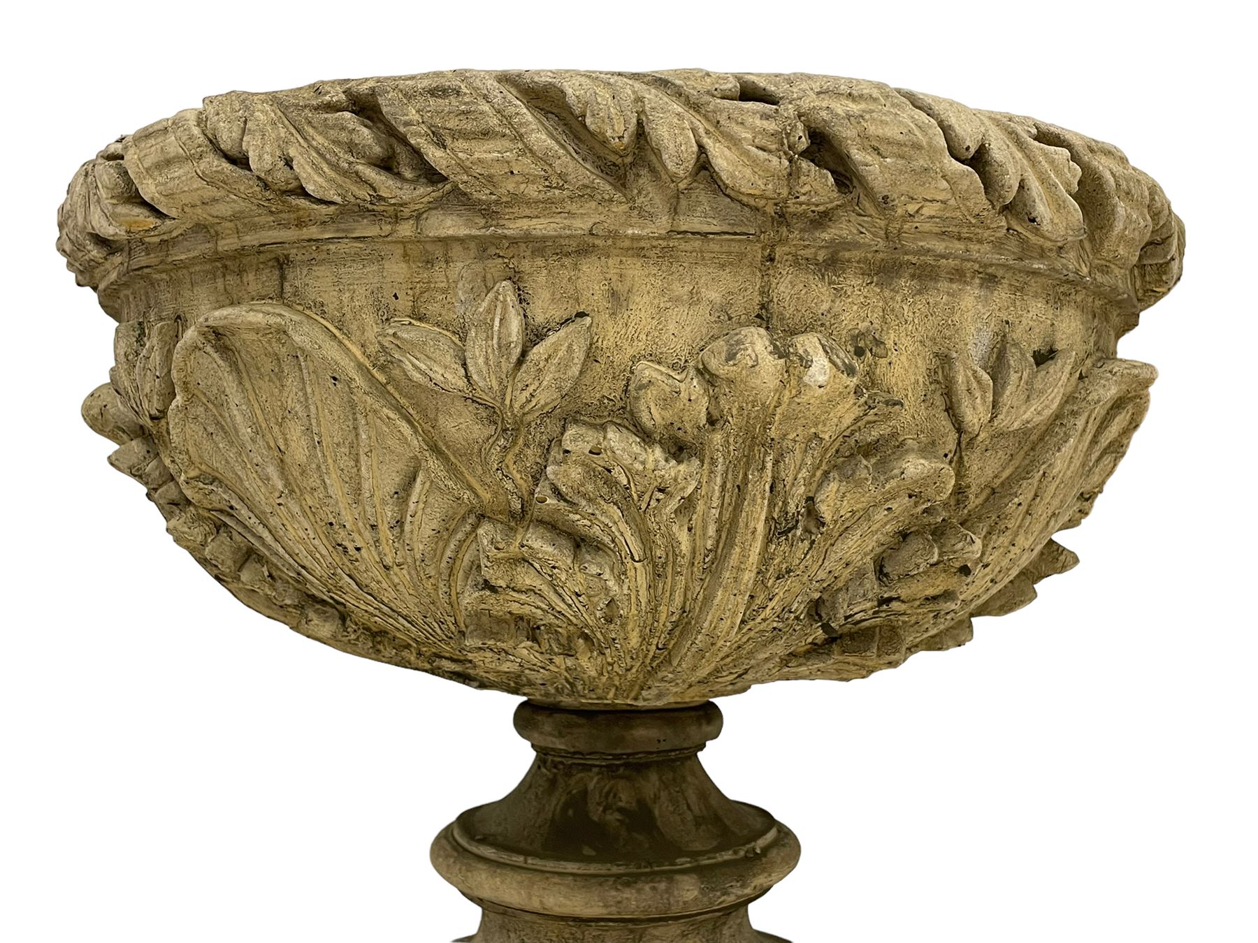 Pair of composite stone garden urn planters, acanthus leaf garland rim over foliate decorated body, stepped foot on square base