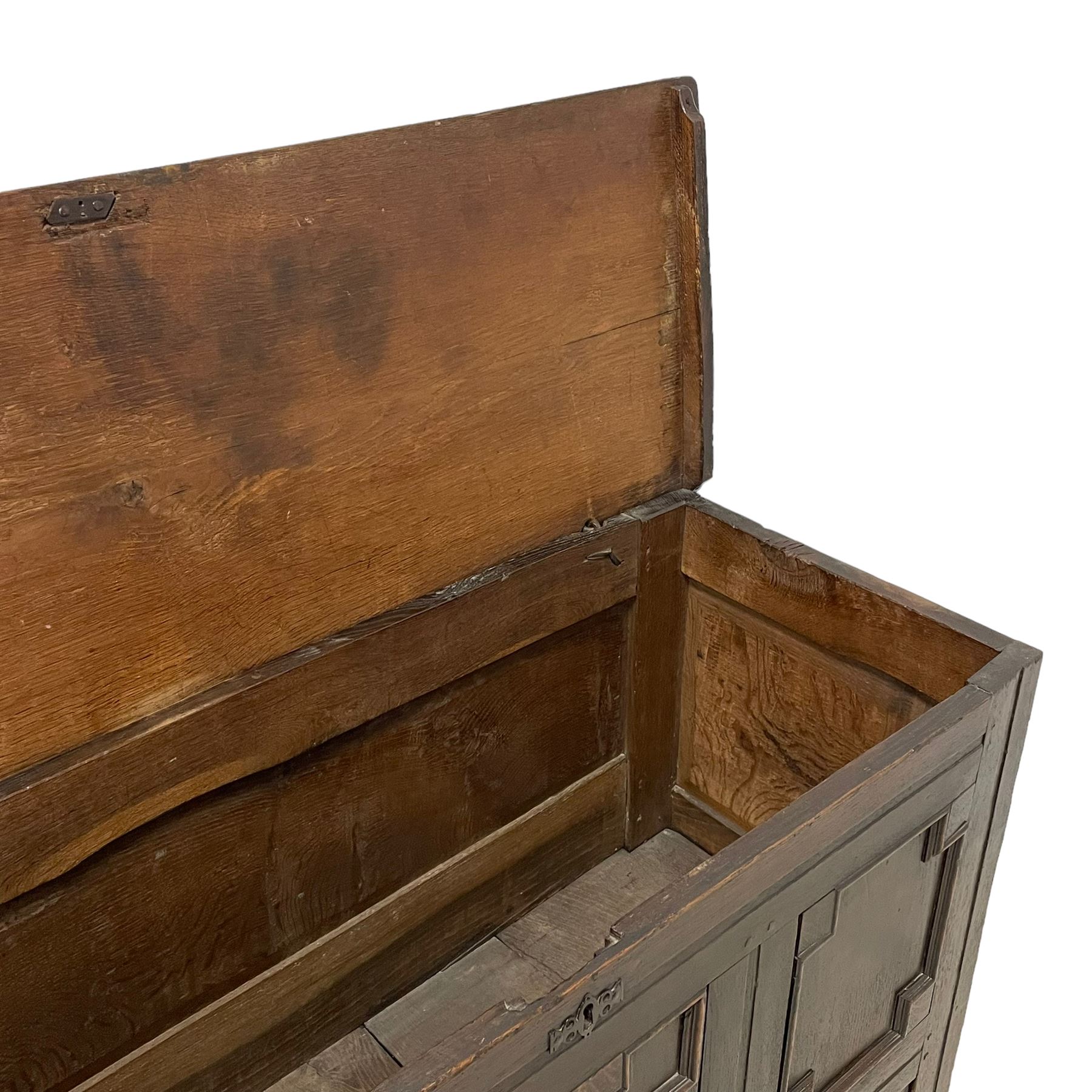 18th century oak mule chest, rectangular hinged top with moulded edge enclosing candle box, the triple panelled front with geometric fielded mouldings, fitted with single drawer to base, raised on stile feet