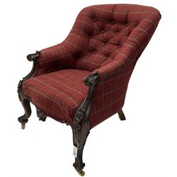 Victorian rosewood framed armchair, upholstered in buttoned tartan fabric, scrolled arm terminals graduating into cabriole supports with moulded flower head decoration and cartouche carved apron, over scroll feet with brass castors