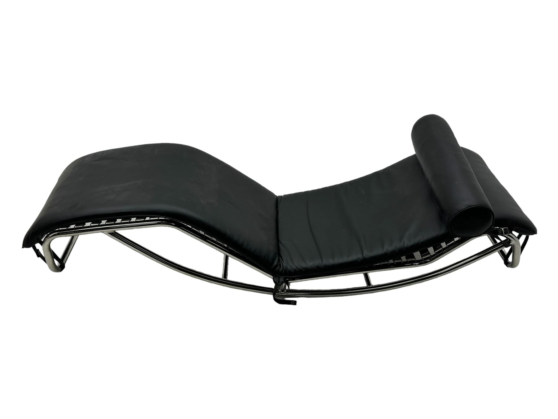 After Le Corbusier, Pierre Jeanneret, and Charlotte Perriand - LC4 chaise longue, black leather upholstery with cylindrical headrest, supported by a chromed tubular steel frame, with cantilever design with elastic webbing