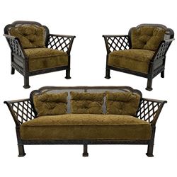 Early 20th century three-piece bergère suite - three seat sofa (W177cm, H82cm, D75cm); pair of matching armchairs (W84cm); single caned back with 'cock-pen' panelled arms, upholstered in foliate pattern fabric, blind fretwork lower frieze over square feet 