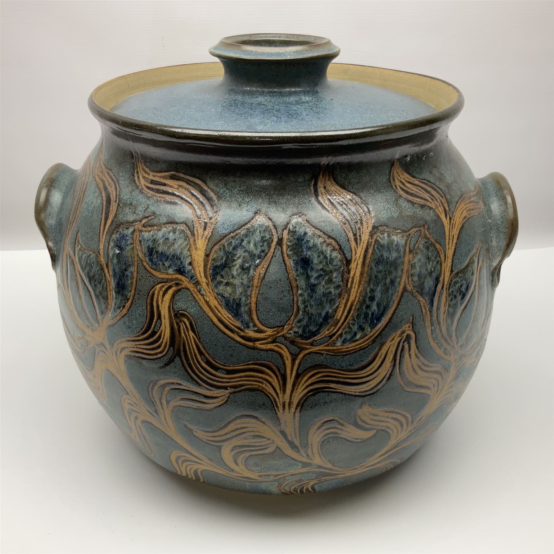 John Egerton (c1945-): studio pottery stoneware large twin handled pot, decorated with flowering sprigs on a blue ground, H33cm