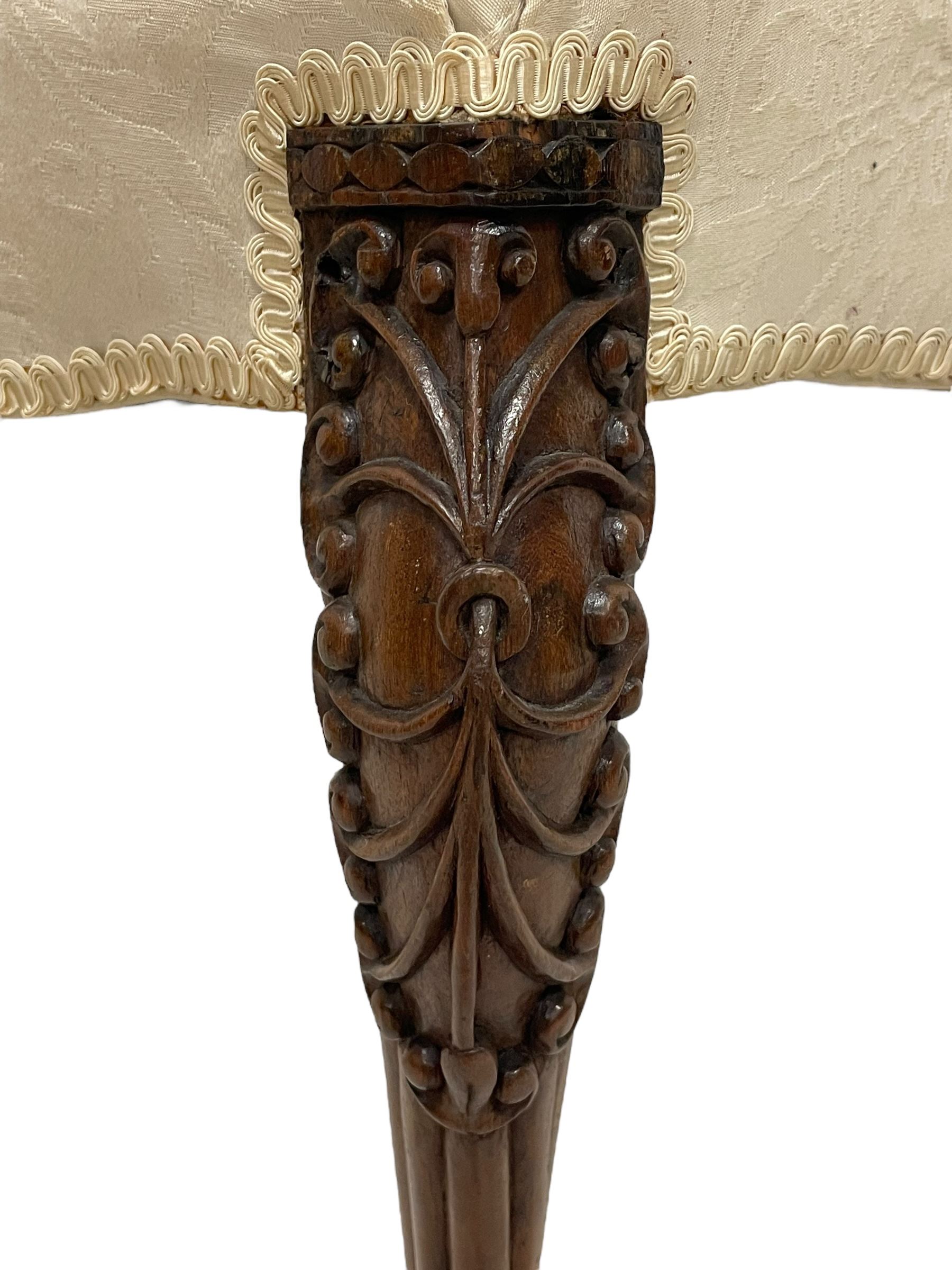 Georgian Irish mahogany dressing stool, overstuffed seat upholstered in in ivory damask fabric, the cabriole supports decorated with moulded interlacing scroll motifs with mycelium cap detail, over lobe carvings terminating to large paw feet