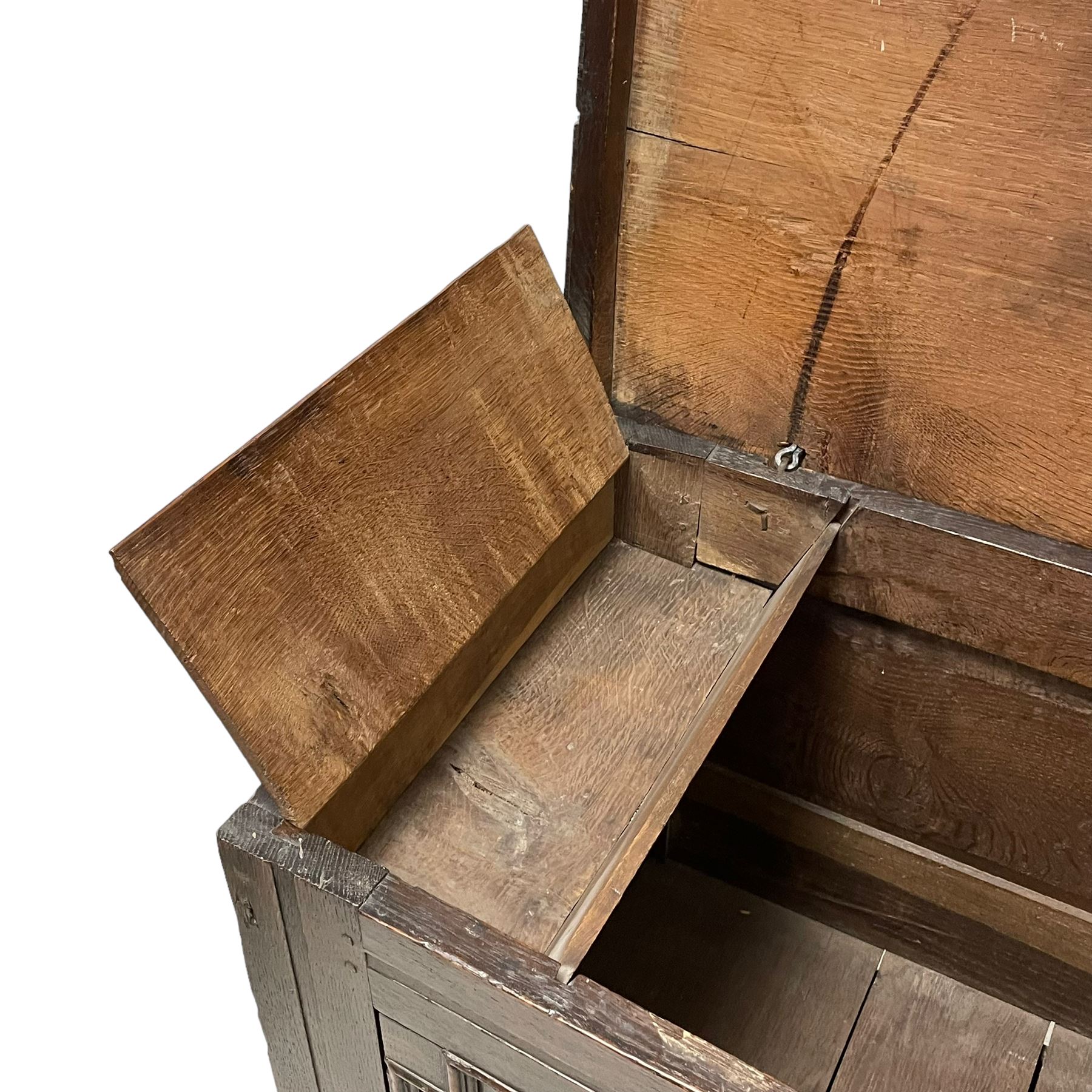 18th century oak mule chest, rectangular hinged top with moulded edge enclosing candle box, the triple panelled front with geometric fielded mouldings, fitted with single drawer to base, raised on stile feet