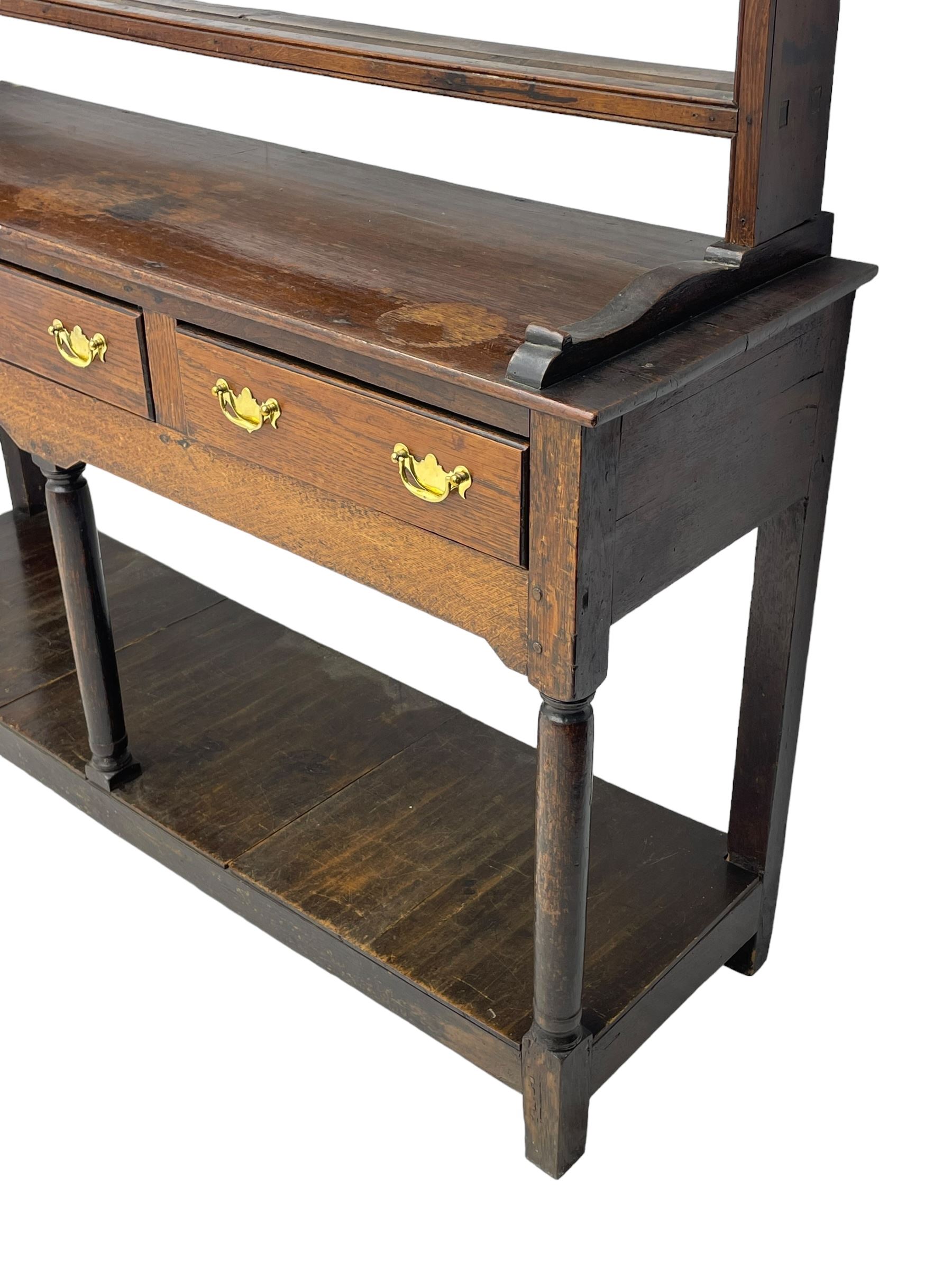 18th century oak dresser, raised three tier plate rack with moulded cresting rail, rectangular top over three drawers, the drawer fronts with moulded edges, turned supports united by pot board base 